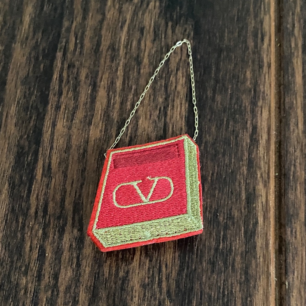 Free with purchase over $10 - Valentino Red and Gold Book Pin